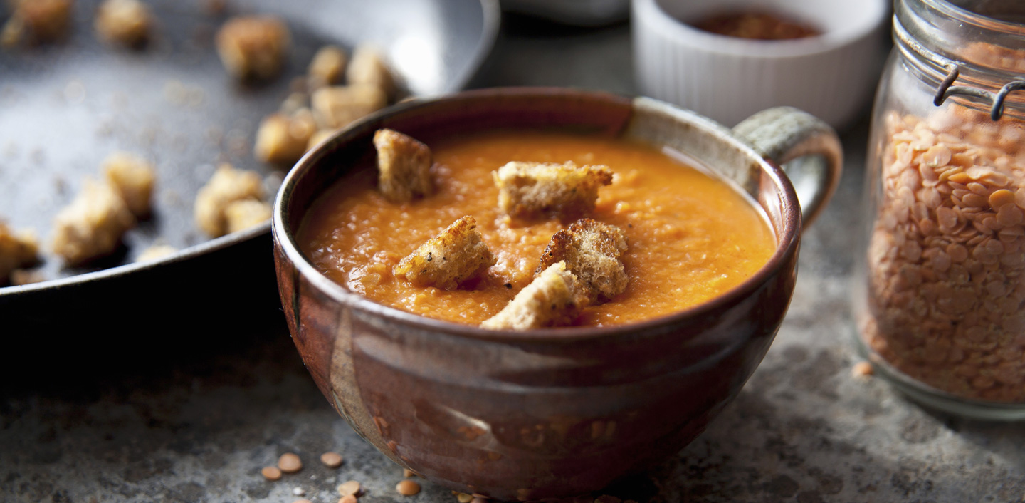 Spicy red lentil soup and tomato with croutons